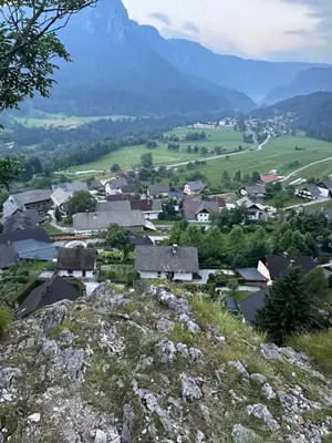 a small village on a hill with mountains in the background at Katja Cottage in Bohinjska Bela