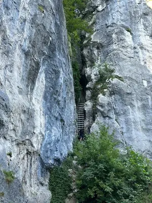 a person standing in a tunnel in the side of a mountain at Katja Cottage in Bohinjska Bela