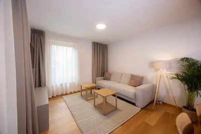 a living room with a couch and a table at Apartments Alpine Nest in Kranjska Gora