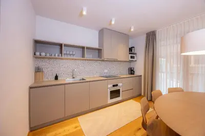 a kitchen with a table and a dining room at Apartments Alpine Nest in Kranjska Gora