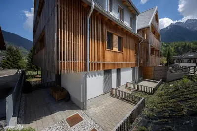 an outside view of a building with a balcony at Apartments Alpine Nest in Kranjska Gora