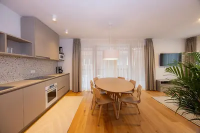 a kitchen and dining room with a table and chairs at Apartments Alpine Nest in Kranjska Gora