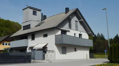 a large white building with a black roof at Apartment Mina in Radovljica