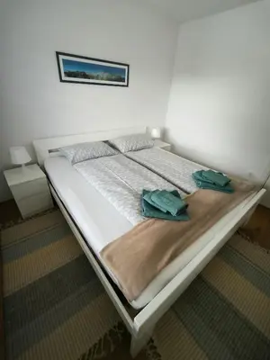 a bed with two towels on it in a bedroom at Apartment Mina in Radovljica