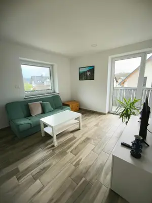 a living room with a couch and a table at Apartment Mina in Radovljica