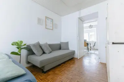 a living room with a couch and a table at Apartment MIDVA in Bled