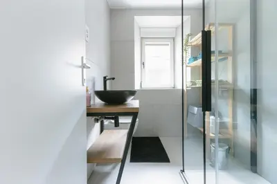 a bathroom with a sink and a desk with a mirror at Apartment MIDVA in Bled