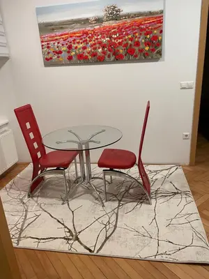 a table and two chairs and a painting of flowers at Topel dom v središču mesta 2 in Maribor