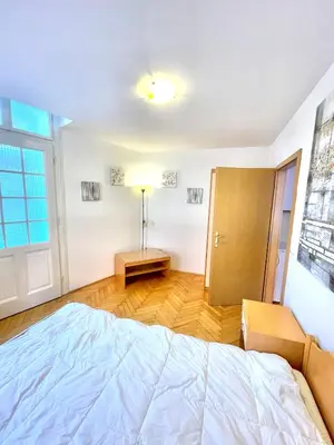 a bedroom with a bed and a lamp in it at Topel dom v središču mesta 2 in Maribor