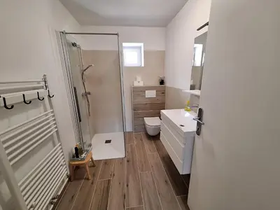 a bathroom with a shower and a toilet and a sink at SummerHouse in Jesenice