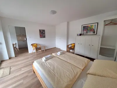 a bedroom with a bed and chairs in it at SummerHouse in Jesenice