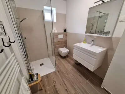 a bathroom with a sink and a toilet and a shower at SummerHouse in Jesenice