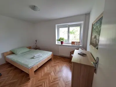 a small bedroom with a bed and a window at SummerHouse in Jesenice