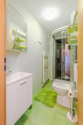 a bathroom with a toilet and a sink and a shower at Penzion Hosnar in Bovec