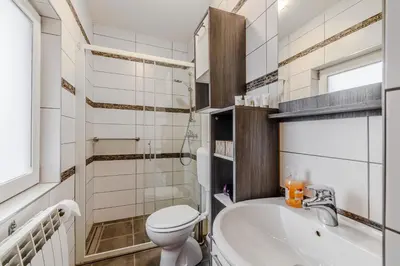 a bathroom with a toilet and a tub and a sink at Penzion Hosnar in Bovec