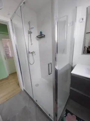 a shower with a glass door in a bathroom at at Silva's place in Ptuj