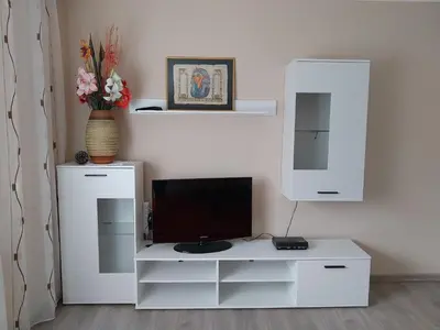 a white entertainment center with a television on top of it at at Silva's place in Ptuj