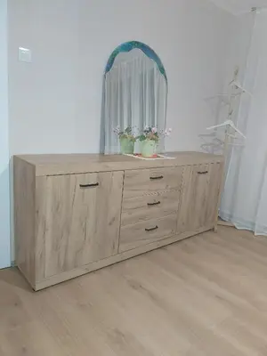 a wooden dresser with a mirror and two plants on it at at Silva's place in Ptuj