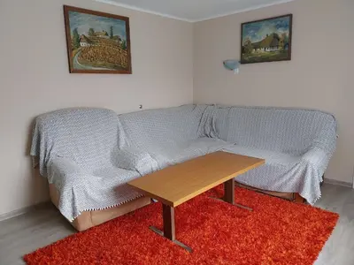 a living room with a couch and a wooden table at at Silva's place in Ptuj