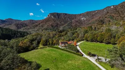 an aerial view of a house in the mountains at Hiša na Hribu- A Peaceful Hilltop Escape above river Kolpa in Kostel