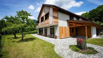 a house with a stone walkway in front of it at Hiša na Hribu- A Peaceful Hilltop Escape above river Kolpa in Kostel