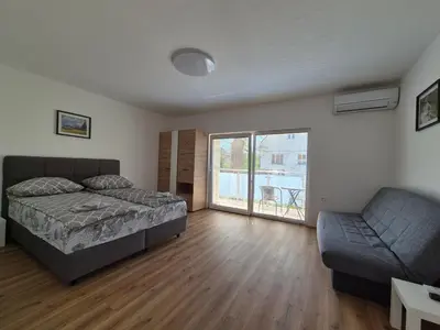a bedroom with a bed and a couch at Villa Vojkova in Ljubljana