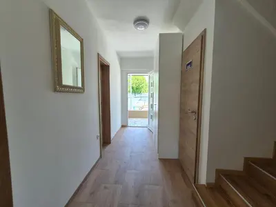 a hallway of a house with a mirror and a door at Villa Vojkova in Ljubljana