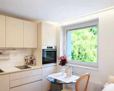 a kitchen with a table and a window at Pinia City Centre Modern Studio with Shared Bathroom in Ljubljana