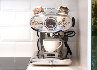 a coffee maker with a cup on top of it at Pinia City Centre Modern Studio with Shared Bathroom in Ljubljana