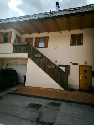 a house with a staircase on the side of it at Garden Apartment Pejić - near Bovec, Soča Valley in Bovec