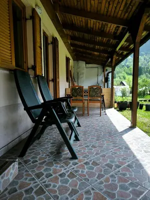 two chairs sitting on the porch of a house at Garden Apartment Pejić - near Bovec, Soča Valley in Bovec
