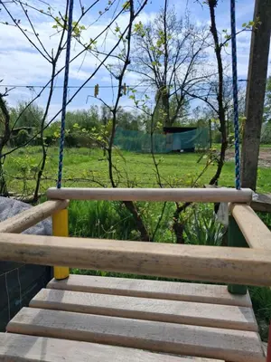 a wooden swing in a park with a field at LAND FOR YOUR TENT NEXT TO A RIVER price includes lands in Croatia and Bosnia as well USE THE PINPOINT LOCATION AND NOT MY HOME ADDRESS BEBLERJEV TRG TO GET TO YOUR ACCOMMODATION bathroom is a bit different so check YouTube video DuskoThreeCountries in Ljubljana