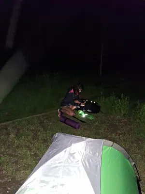 a person sitting on the ground next to a tent at LAND FOR YOUR TENT NEXT TO A RIVER price includes lands in Croatia and Bosnia as well USE THE PINPOINT LOCATION AND NOT MY HOME ADDRESS BEBLERJEV TRG TO GET TO YOUR ACCOMMODATION bathroom is a bit different so check YouTube video DuskoThreeCountries in Ljubljana