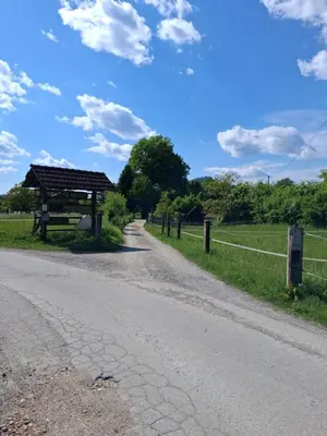 a dirt road next to a fence and a woodenilion at LAND FOR YOUR TENT NEXT TO A RIVER price includes lands in Croatia and Bosnia as well USE THE PINPOINT LOCATION AND NOT MY HOME ADDRESS BEBLERJEV TRG TO GET TO YOUR ACCOMMODATION bathroom is a bit different so check YouTube video DuskoThreeCountries in Ljubljana