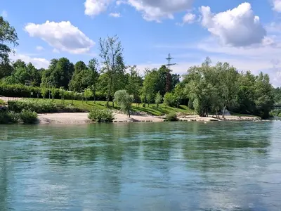 a river with trees and a cross in the distance at LAND FOR YOUR TENT NEXT TO A RIVER price includes lands in Croatia and Bosnia as well USE THE PINPOINT LOCATION AND NOT MY HOME ADDRESS BEBLERJEV TRG TO GET TO YOUR ACCOMMODATION bathroom is a bit different so check YouTube video DuskoThreeCountries in Ljubljana