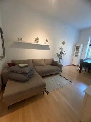 a living room with a couch and a table at Feel good Stay at Dragon bridge Apartment in Ljubljana