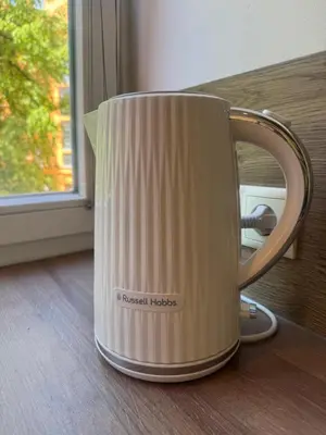 a coffee cup sitting on a table next to a window at Feel good Stay at Dragon bridge Apartment in Ljubljana