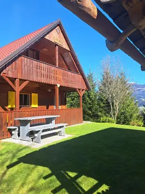 a pavilion with a picnic table on a lawn at Na Rebri in Luče