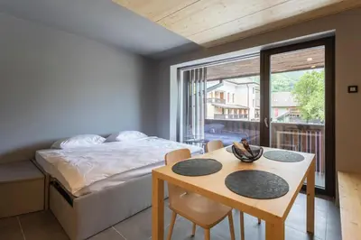 a bedroom with a bed and a table and a table sidx sidx sidx at Alpine Nest Bovec in Bovec