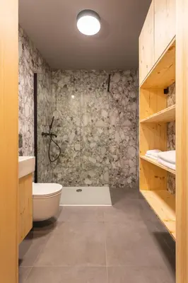 a bathroom with a shower and a toilet and a sink at Alpine Nest Bovec in Bovec