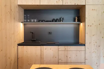 a kitchen with wooden cabinets and a counter top at Alpine Nest Bovec in Bovec