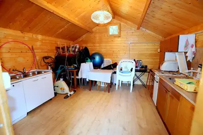 a kitchen and dining room with a table and chairs at Chalet Gorske Sanje - Kranjska Gora in Gozd Martuljek