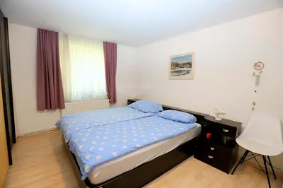 a bedroom with a bed with blue pillows on it at Chalet Gorske Sanje - Kranjska Gora in Gozd Martuljek