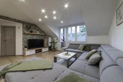 a living room with a couch and a tv at Lili Rooms in Stahovica