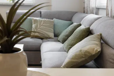 a couch with pillows on it in a living room at Lili Rooms in Stahovica