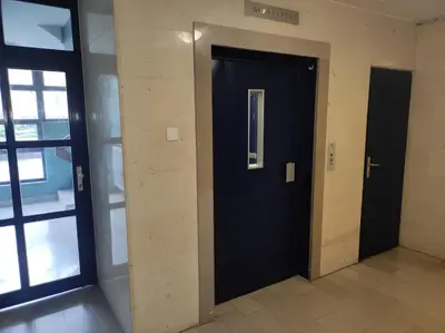 a hallway with a black door in a building at MCS Metro Residence in Ljubljana