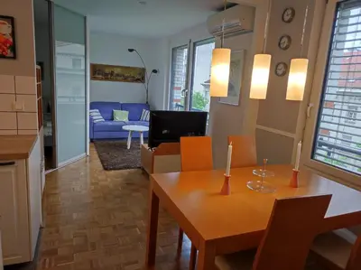 a living room with a table and a couch at MCS Metro Residence in Ljubljana