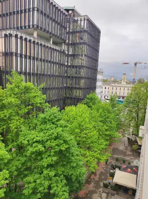 a view of a building with trees in front of it at MCS Metro Residence in Ljubljana