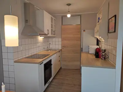 a kitchen with white cabinets and a counter top at MCS Metro Residence in Ljubljana
