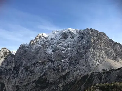 a mountain with snow on top of it at Planinski dom - Mihov dom na Vršiču in Kranjska Gora
